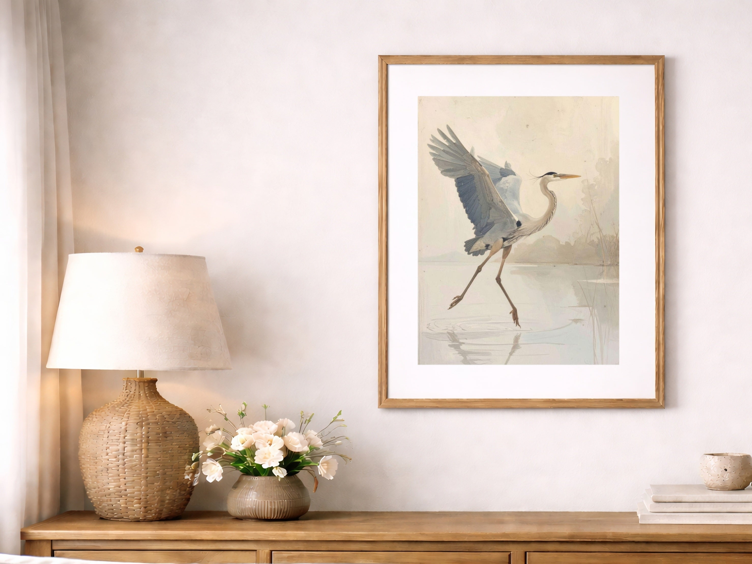Graceful heron wall art in neutral coastal living room, soft beige tones, minimalist nature decor, framed bird print above console, serene modern farmhouse styling.
