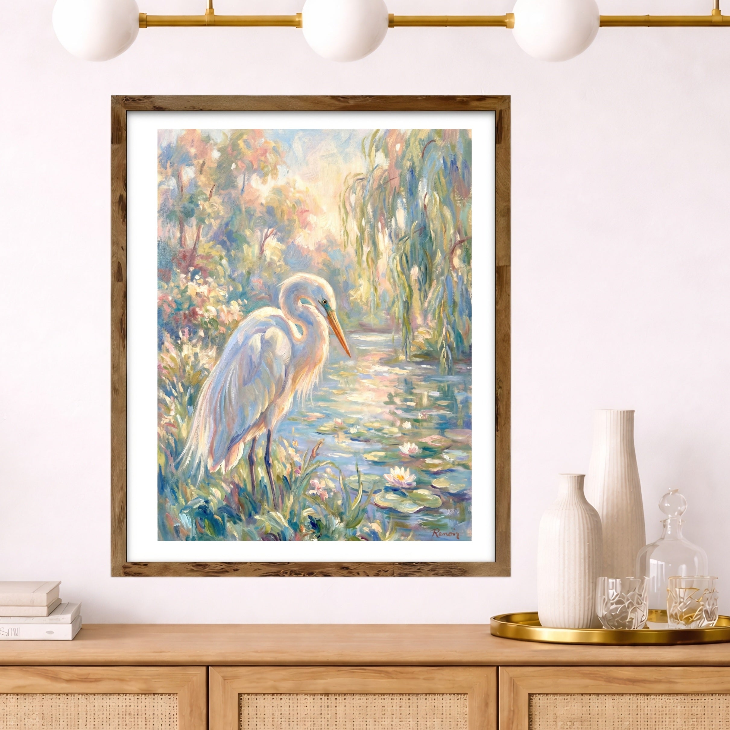 Framed painting of a egret in a natural setting on a wall above a wooden console table.