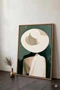 Minimalist woman with hat wall art leaning against wall with wood floor and neutral decor, modern portrait styled in simple space