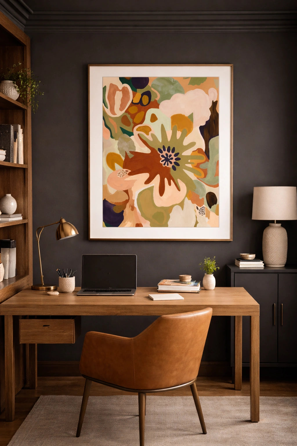 Abstract botanical wall art in modern home office with dark walls, wood desk, and leather chair, earthy tone printable decor above workspace