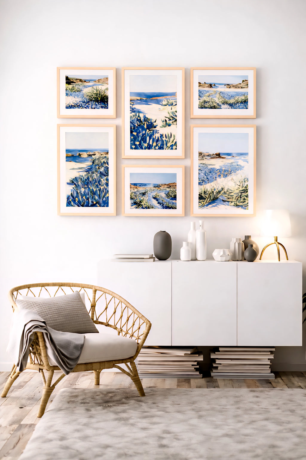Coastal gallery wall printable art bundle with blue seascape prints in light wood frames creating a soft modern neutral living room decor layout