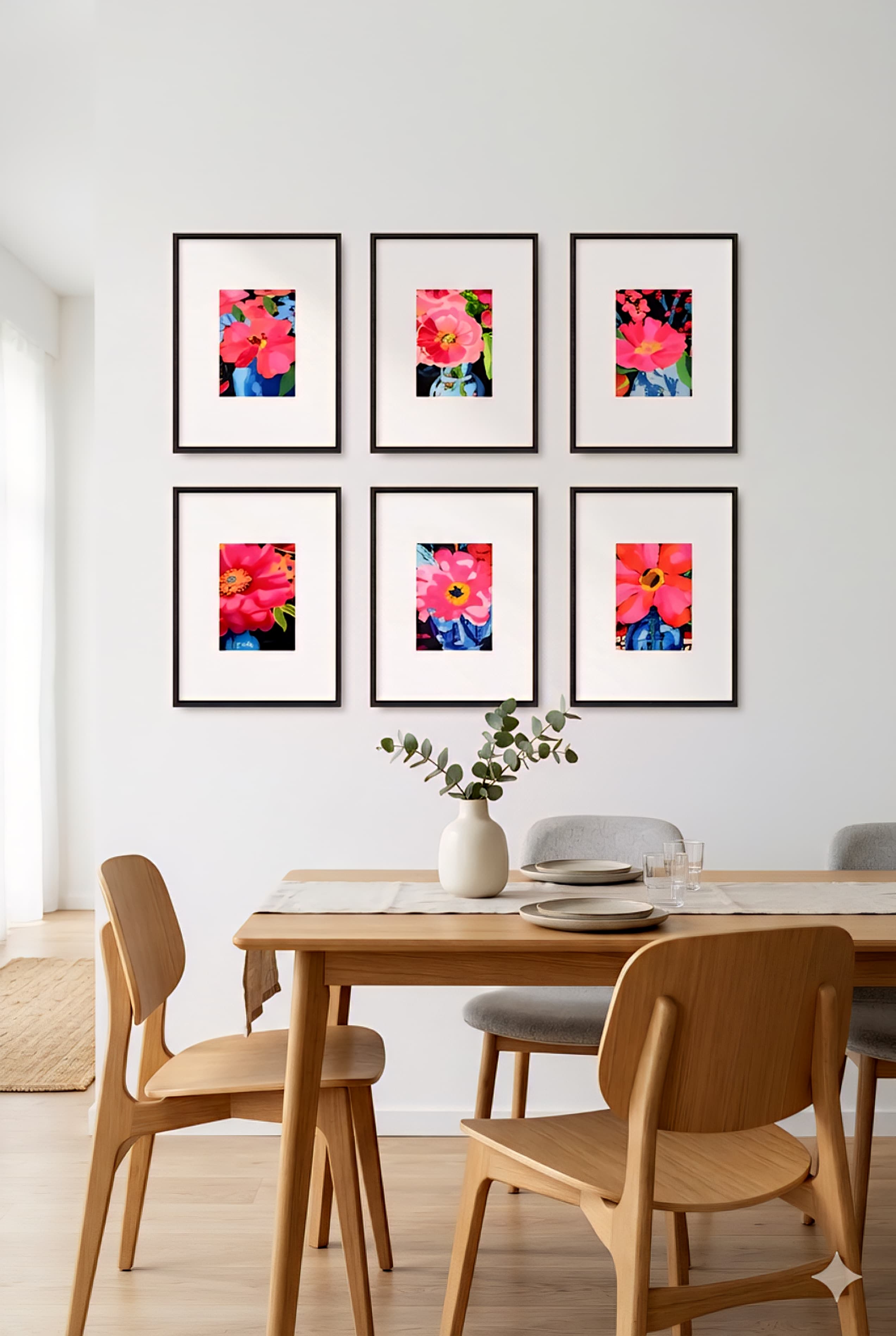 Scandinavian dining room featuring six pink pop art flower prints in black frames arranged in a grid above a light wood table, styled with neutral tones and minimalist decor