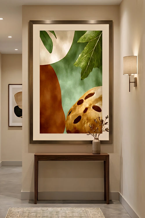 Large vertical earth tone abstract botanical wall art with green leaves and warm terracotta shapes styled in a modern neutral hallway, oversized framed print above wood console table with soft lighting and minimal decor for upscale entryway design