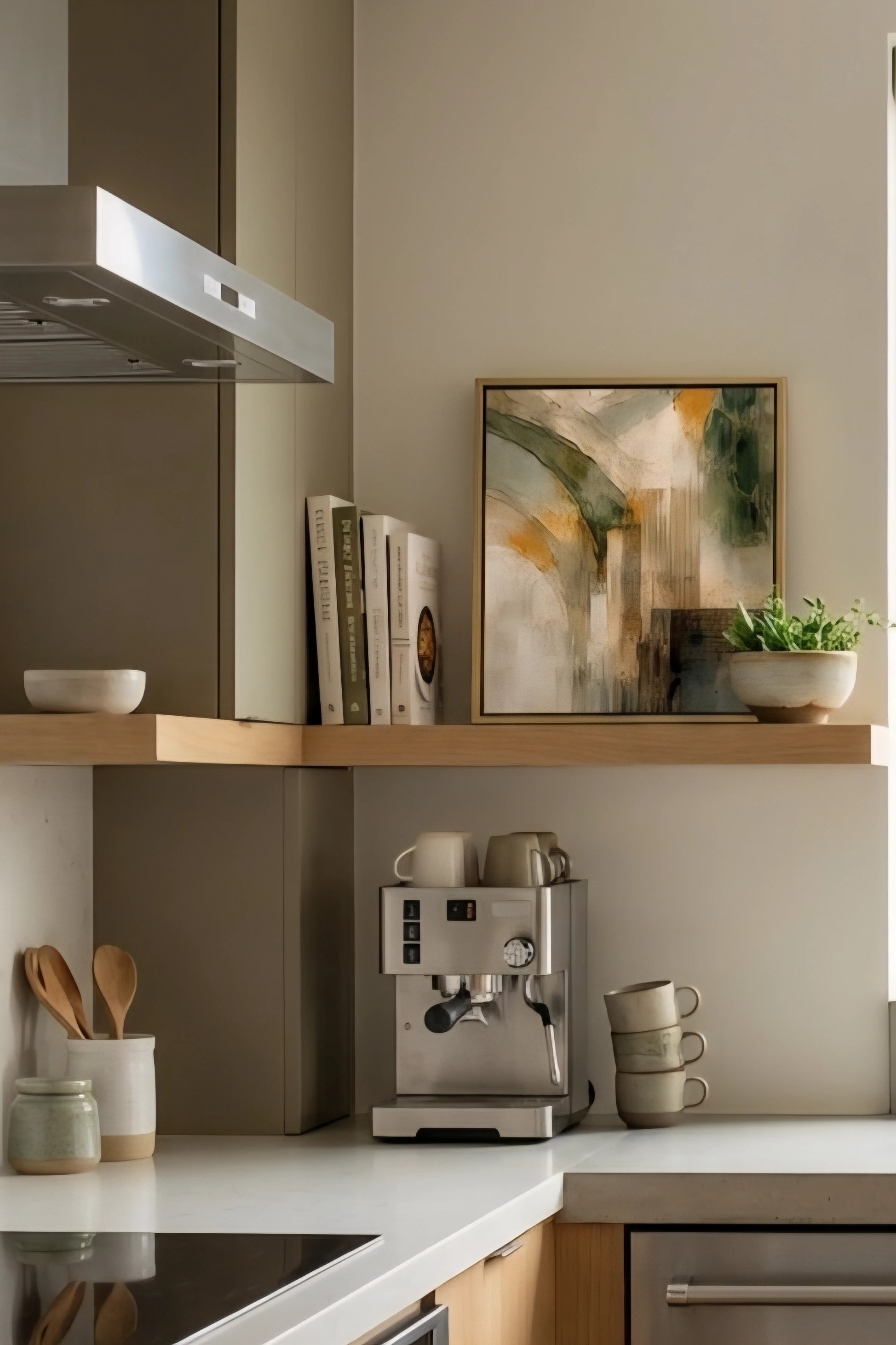 Earth tone abstract wall art in small frame styled on kitchen shelf with books, plant, and coffee setup, neutral modern decorinspo