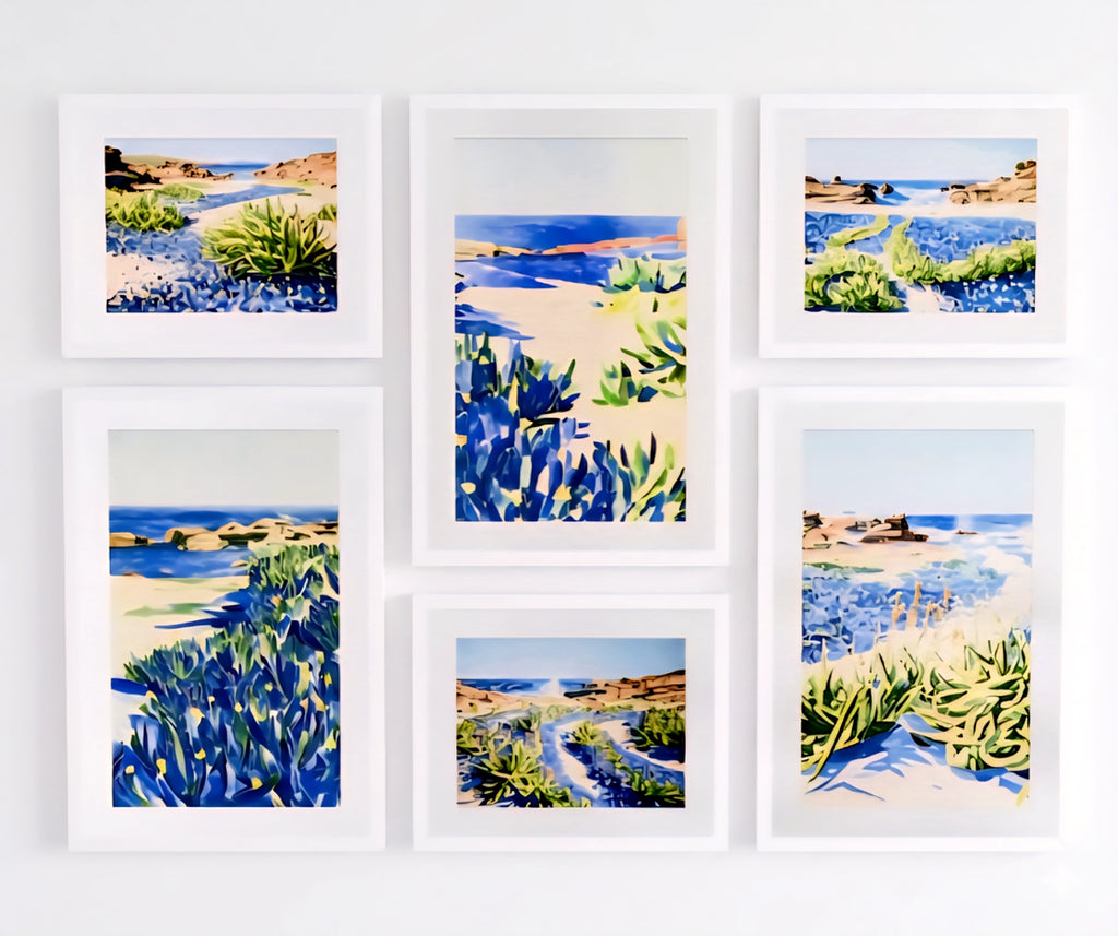 Coastal gallery wall printable art bundle featuring blue seascape prints in white frames arranged in a clean symmetrical layout for modern home decor