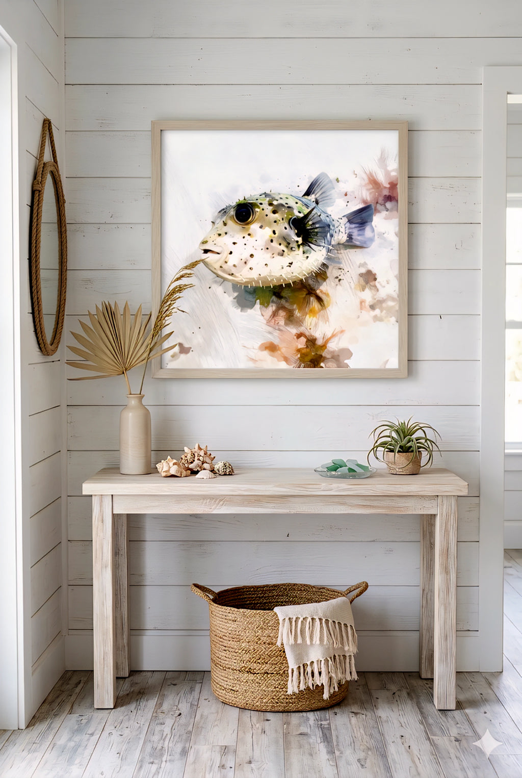Neutral coastal room with a digital artwork of a puffer fish, a table with decorative items, and a woven basket.