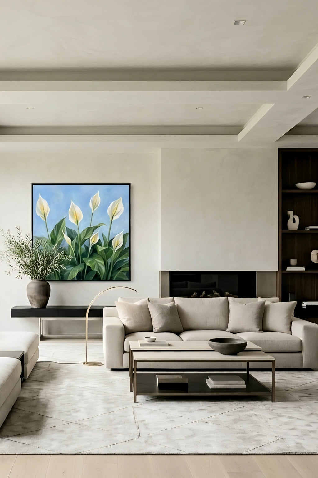 Framed peace lily botanical wall art with white blooms and green leaves on a blue background styled above a sofa in a modern neutral living room, printable digital download