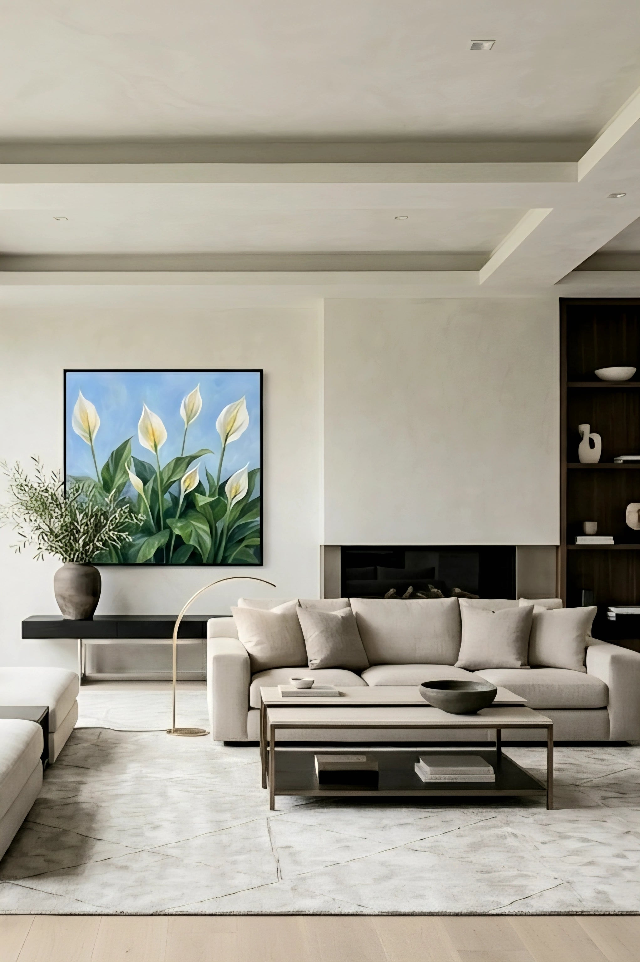 Framed peace lily botanical wall art with white blooms and green leaves on a blue background styled above a sofa in a modern neutral living room, printable digital download