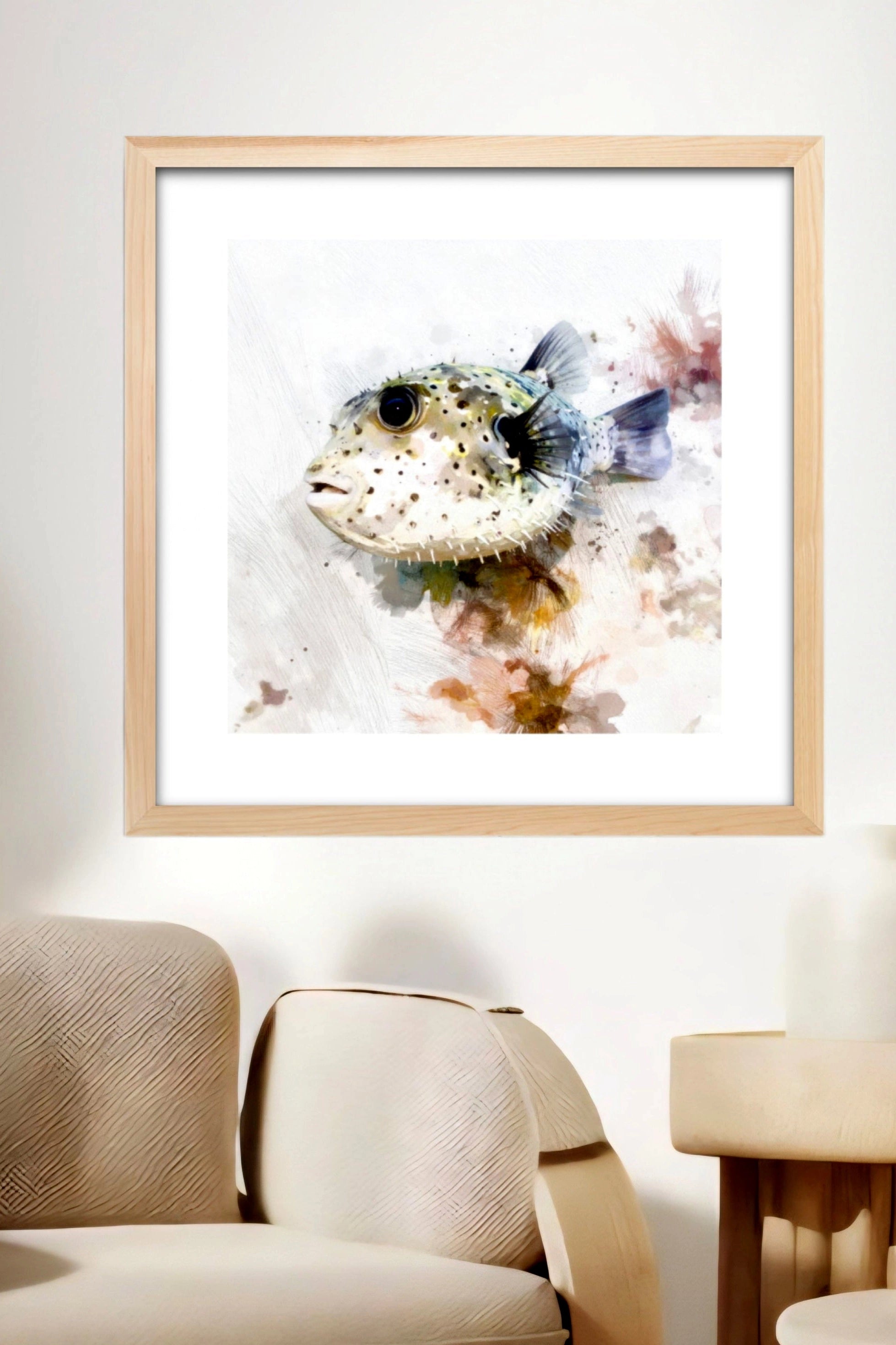 Neutral puffer fish on a wall above a beige sofa. Fish produced from digital download. 