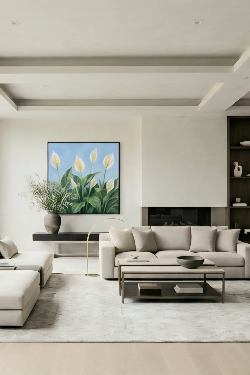 Framed peace lily botanical wall art with white blooms and green leaves on a blue background styled above a sofa in a modern neutral living room, printable digital download
