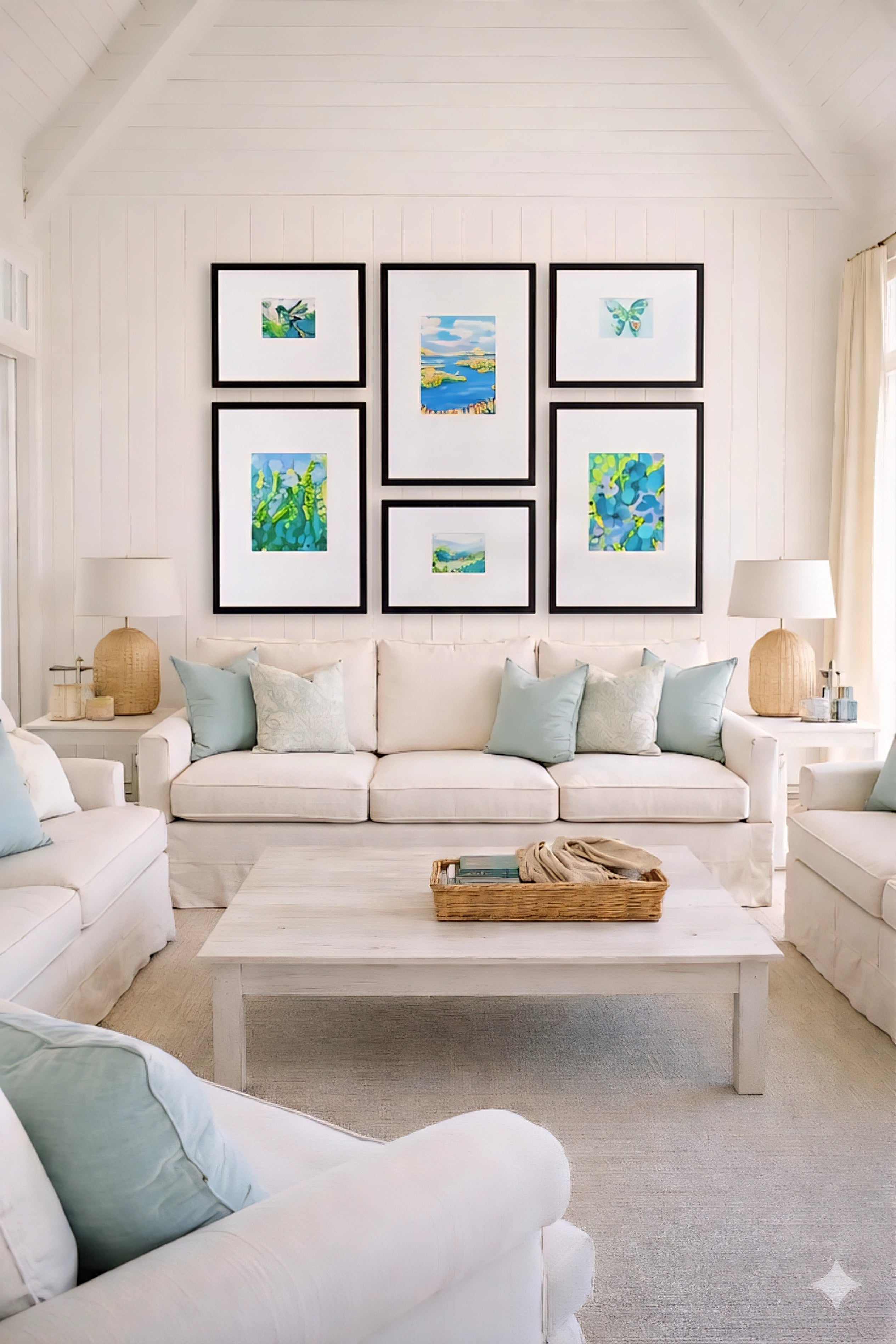 Savvy Places coastal gallery wall printable set in black frames styled above sofa, blue green beach artwork creating a bright modern coastal living room decor look