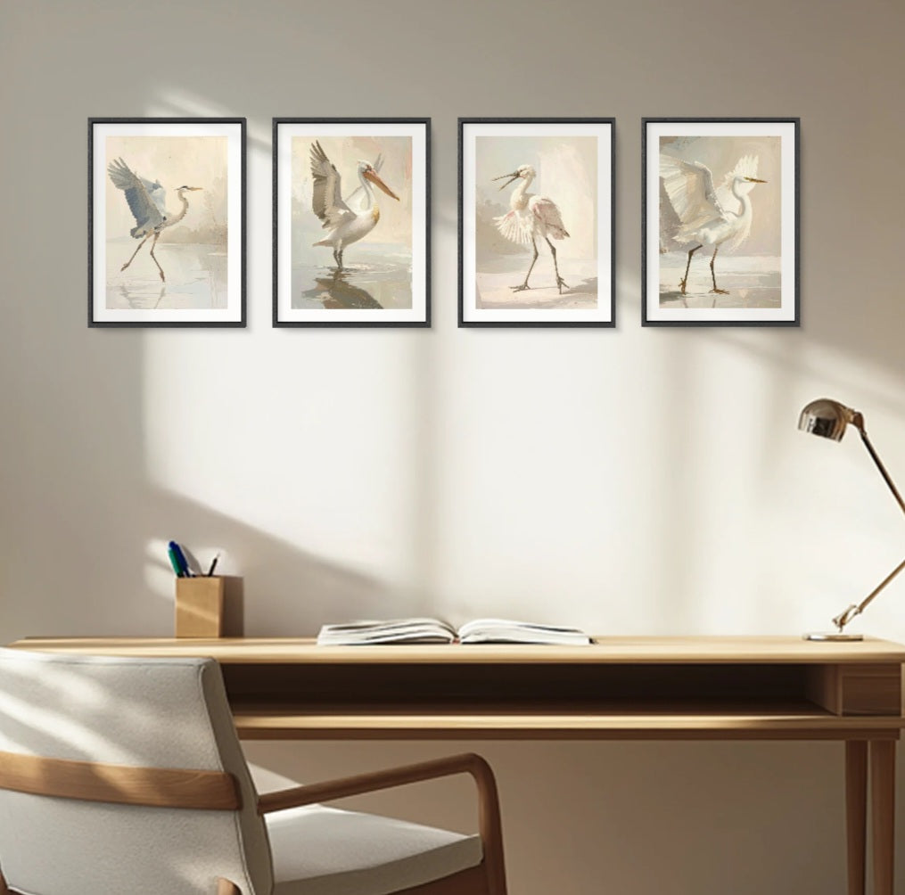 Four framed digital  prints of coastal  birds on a wall above a desk with a lamp and chair.