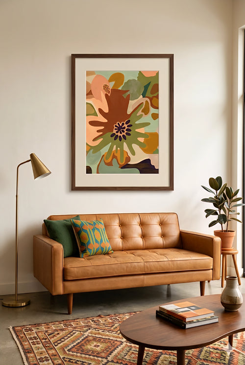 Savvy Places abstract floral wall art in warm earthy tones styled above a leather sofa in a modern living room setting.
