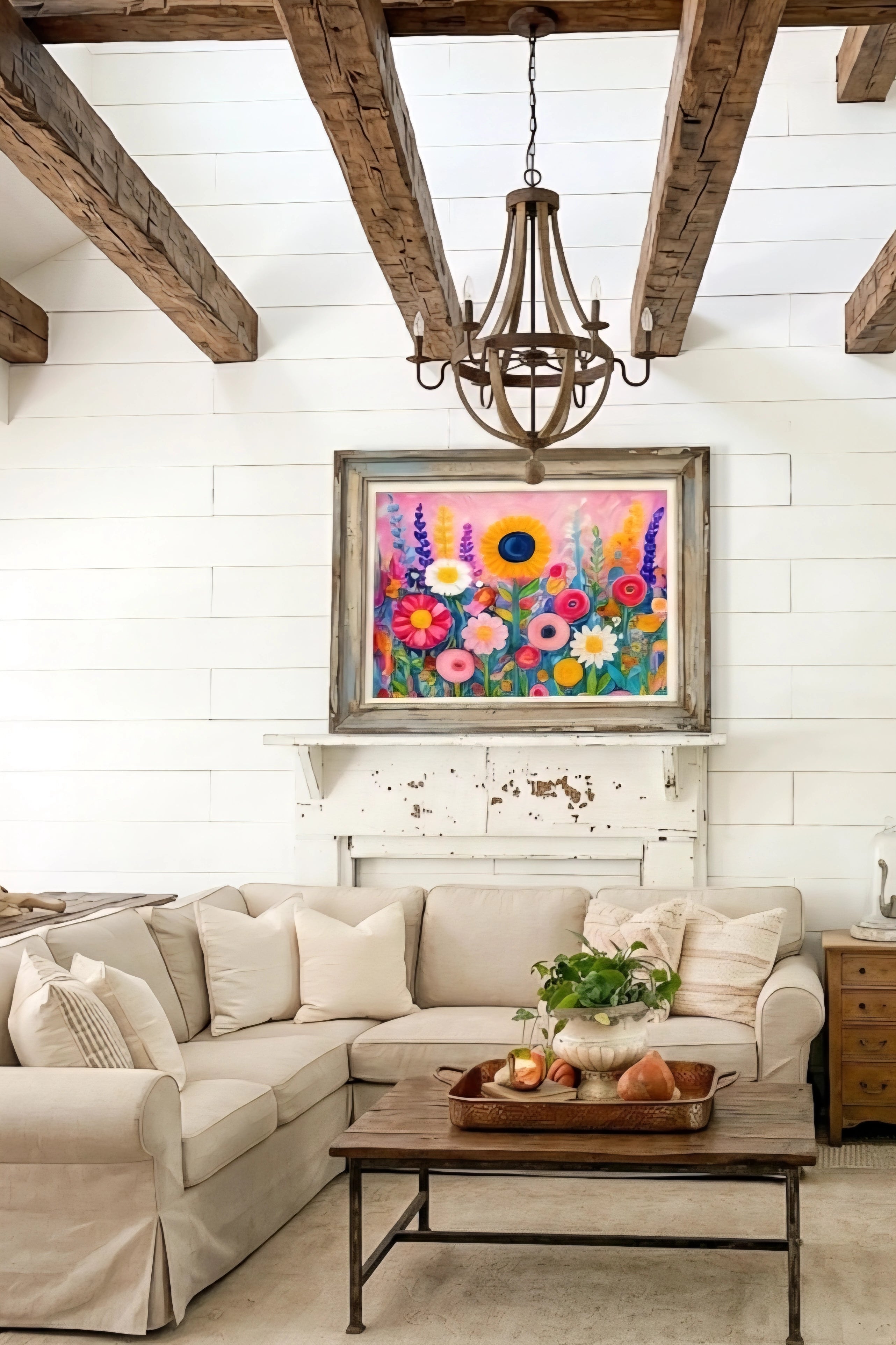 Colorful floral wall art printable in rustic wood frame above mantel, featuring vibrant wildflowers and sunflower on pink abstract background in modern farmhouse living room