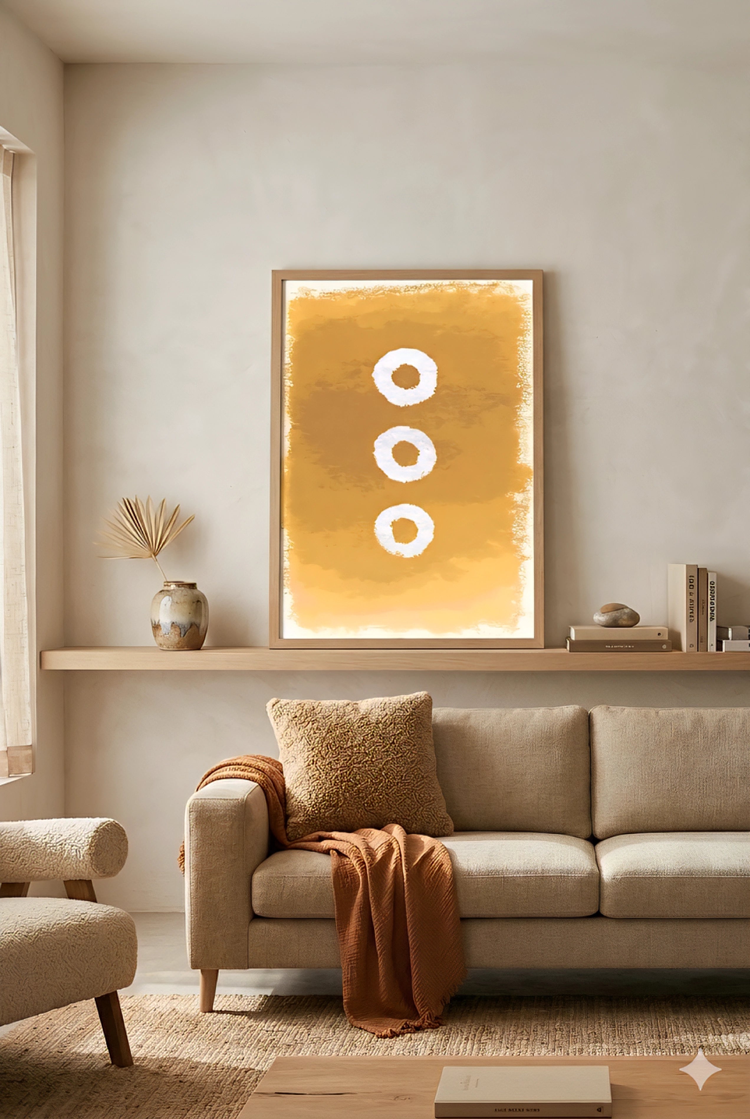 Large abstract wall art printable in warm golden earth tones with three circular shapes, displayed above a beige sofa with wood shelf styling in a modern minimalist living room, oversized 9:16 vertical decor