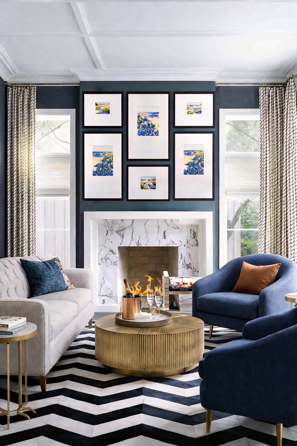 Coastal gallery wall printable art bundle displayed above fireplace with blue seascape prints in black frames creating a bold modern living room focal point decor
