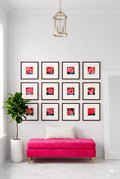 Bright entryway savvy places gallery wall featuring twelve pink pop art flower prints in black frames arranged in a grid above a pink bench, styled with a potted plant and modern lighting