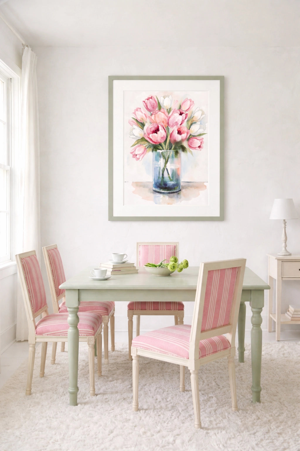 Dining room with a table and chairs, a framed picture of pink tulips on the wall, and a lamp.