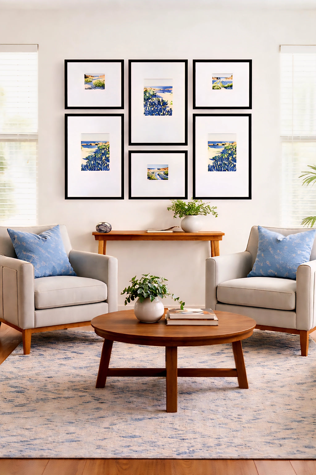 Modern coastal gallery wall bundle printable art set displayed above console table with blue seascape prints in black frames creating a cohesive living room decor layout