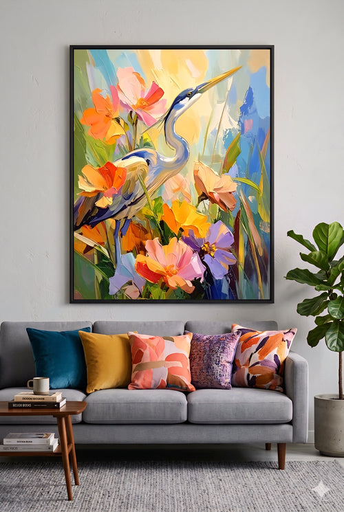 Large colorful heron floral wall art above gray sofa with vibrant pillows, modern living room decor idea featuring bold bird painting print that adds color, contrast, and designer style to neutral spaces