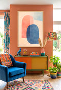 Colorful boho living room with abstract midcentury digital art, and decorative items.
