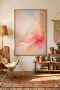 Boho living room with coral abstract printable wall art, warm neutral tones, leather chair, macrame wall hanging, plants, and cozy textured decor styling