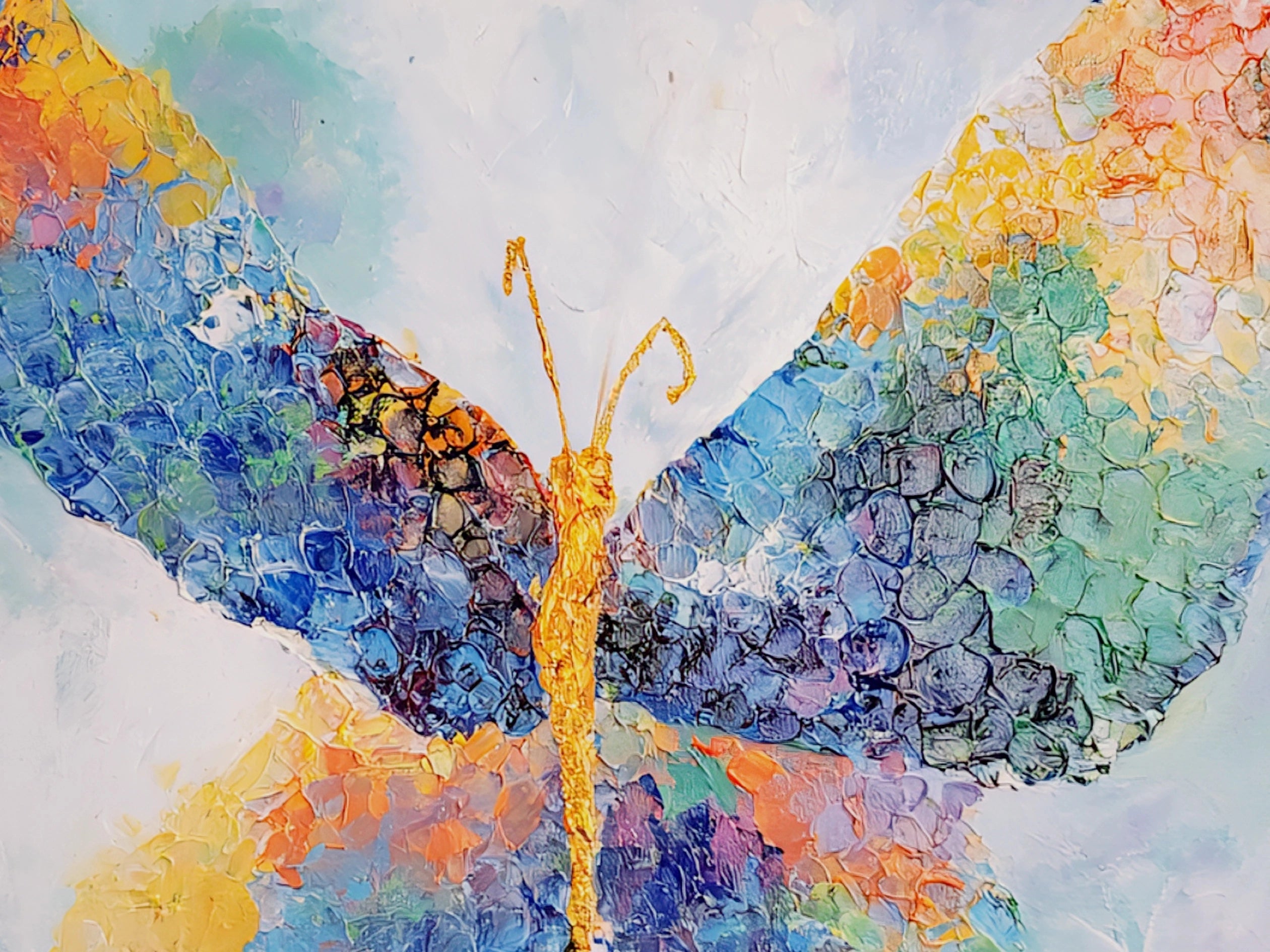 Close-up of colorful abstract horizontal butterfly painting with thick textured brushstrokes in blue, teal, orange, and gold, showcasing detailed impasto surface and vibrant modern artwork design