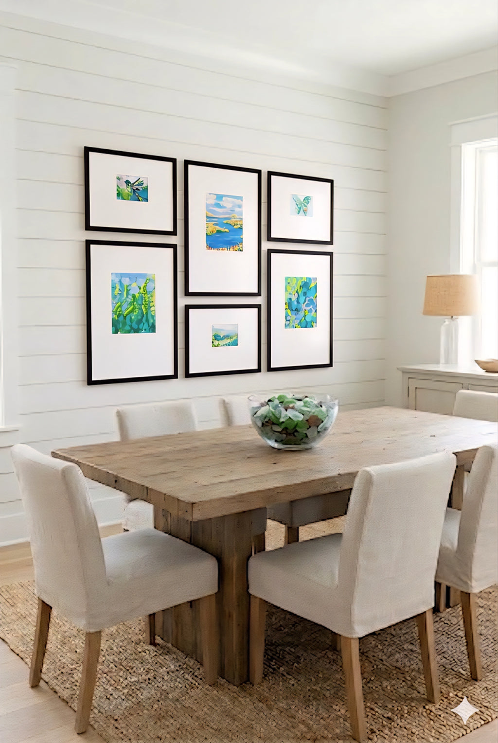 coastal gallery wall printable set in black frames styled above dining table, blue green beach artwork for modern coastal dining room decor