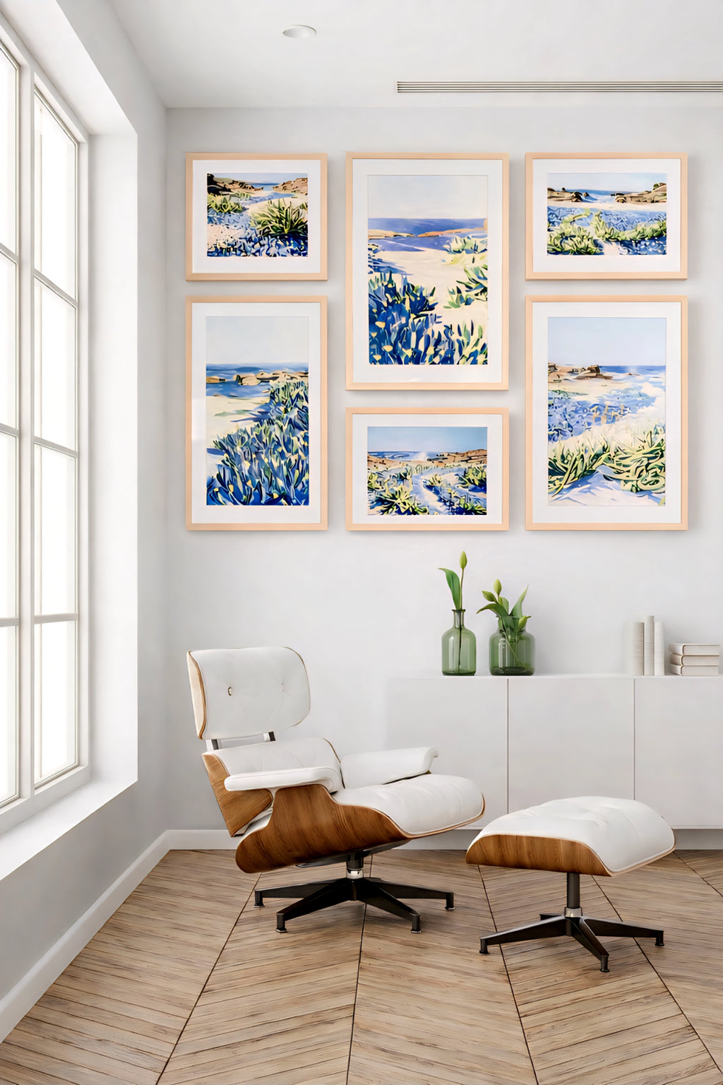 Coastal gallery wall printable art bundle with blue seascape prints in light wood frames creating a clean modern reading nook decor layout
