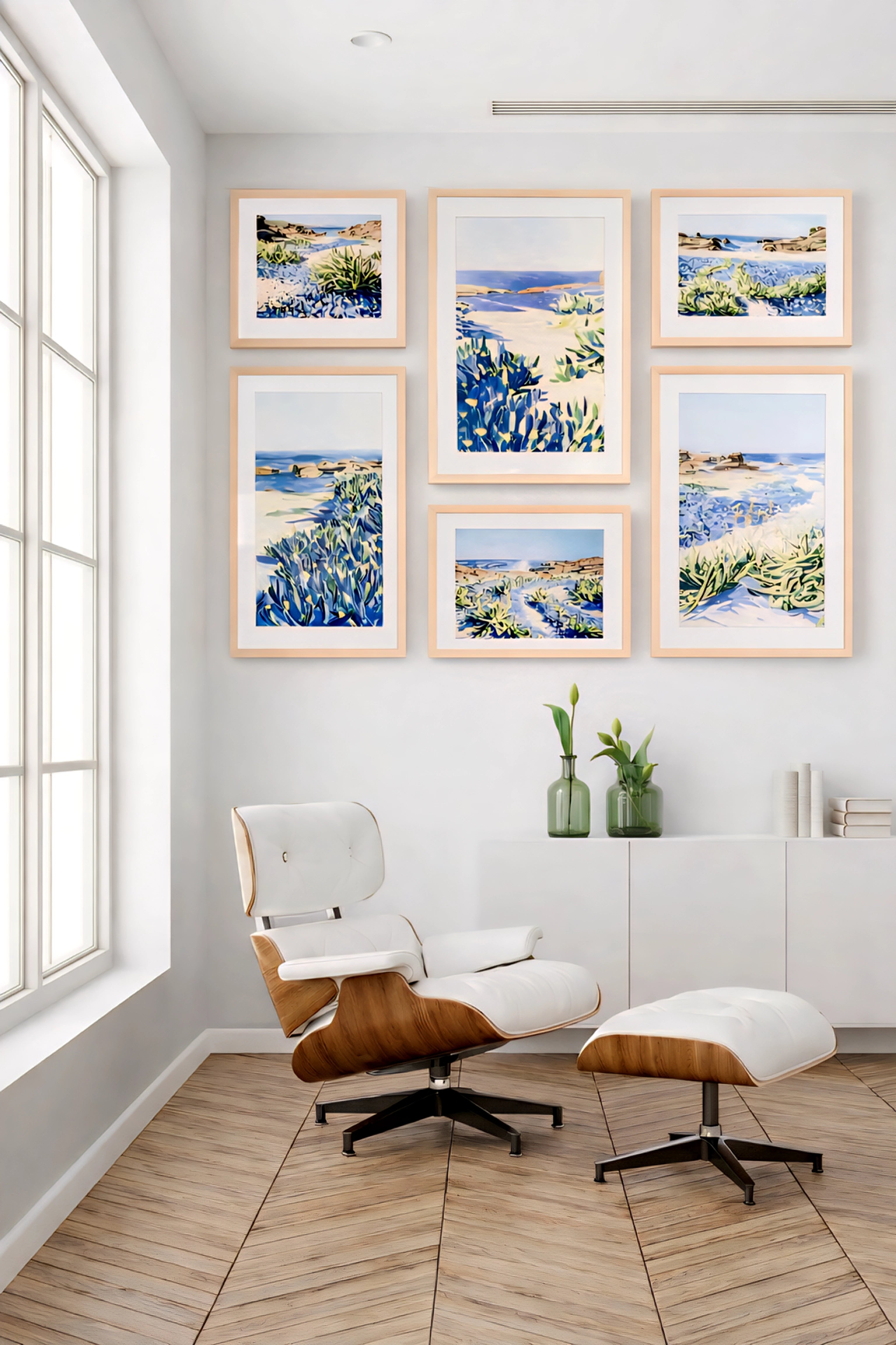 Coastal gallery wall printable art bundle with blue seascape prints in light wood frames creating a clean modern reading nook decor layout